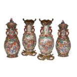 A garniture of four Chinese export porcelain 'Mandarin palette' vases, Qianlong period, each moulded