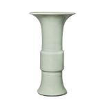 A Chinese porcelain celadon-glazed beaker vase, gu, 19th century, the elongated midsection atop a