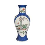 A large Chinese porcelain powder-blue famille verte 'scholar's objects' vase, 19th century, with two