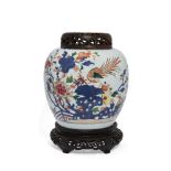 A Chinese porcelain famille rose 'phoenix' jar, 18th century, painted with a phoenix stood atop a