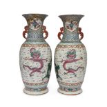 A pair of large Chinese porcelain famille rose 'dragon' vases, 19th century, painted with four-