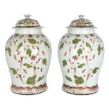 A pair of Chinese porcelain famille rose 'blossom' jars and covers, 19th century, each painted to