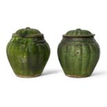 A pair of Chinese pottery green-glazed jars and covers, Ming dynasty, each jar with lobed sides that