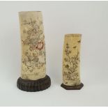 Two Japanese Meiji Period ivory tusk vases mounted on wooden stands, late 19th century, originally