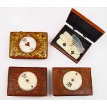 A set of four French games boxes, late 18th century, each stained red with gilt design, the lids