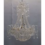 A glass and silvered four-light chandelier, late 20th century, the circlets with facetted squares,