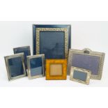A group of seven easel back photo frames comprising: a rectangular silver example with bow and