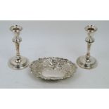 A pair of silver candlesticks, Birmingham, marks rubbed, the urn-shaped capitals to tapering stems