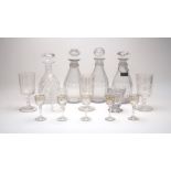 A group of Georgian glassware, to include three decanters with fluted bodies and diamond cut