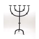 A wrought iron five arm candelabra, the branching arms and stem with knops, on tripod base, 60cm