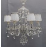 A glass six-light chandelier, late 20th century, the canopy hung with faceted drops above a baluster