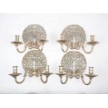 A set of four Charles II silvered metal twin branch wall lights, second half 20th century, each with