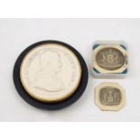 A plaster cast of the medal of Pope Pius IX, with ebonized wood stand, 6.3cm diameter, together with