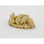 A Japanese Ivory netsuke, late Meiji period, carved as five rats on a shell, each with inlaid