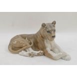 A Royal Copenhagen glazed recumbent lioness, makers mark to underside, 32cm long Please refer to