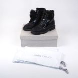Jimmy Choo: a pair of black shiny calf leather lace-up snow boots, shearling lined with heated