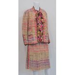 Chanel Couture, a two piece loose woven jacket band skirt suit, multi-coloured on a cream ground