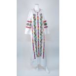 Muzungu Sisters: a Jasmin Vine white kaftan dress with multicolour hand embroidered floral motif
