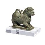 A bronze lion, South India, 18th century, depicted crouching, his legs bent and tail curled up and