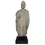 A Gandhara life size standing standing figure of Buddha, 2nd/3rd century, wearing a full length