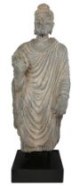 A Gandhara life size standing standing figure of Buddha, 2nd/3rd century, wearing a full length