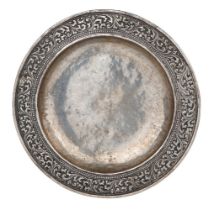 A rare early chased and repousse work silver dish, India, 17th century, of deep form with wide