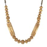 A South Indian gold necklace, 19th century, comprised of a series of graduating fluted and