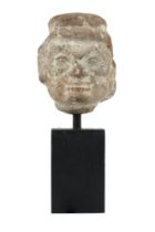 A Gupta period terracotta head, India, circa 4th century, depicted with wide set eyes, a top knot