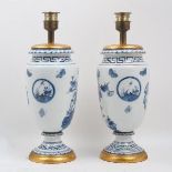A pair of Chinoiserie blue and white baluster table lights, 20th century, each decorated with floral