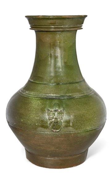 A Chinese pottery green-glazed vase, hu, Han dynasty, the pear-shaped body decorated with moulded