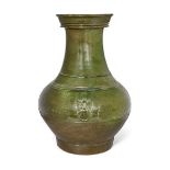 A Chinese pottery green-glazed vase, hu, Han dynasty, the pear-shaped body decorated with moulded