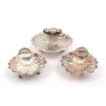 A pair of silver scallop shell dishes, Birmingham, 1968, A Marston & Co., raised on three scroll