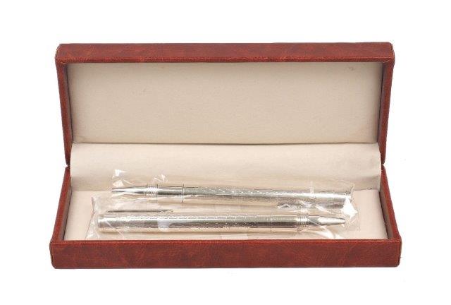 A cased pair of silver ballpoint pens, London, 2014, SJ, designed with engine turned pattern to