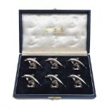 A cased set of six silver dolphin place card holders, by Garrard, London, 1997, each designed