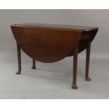 A George II mahogany drop leaf table, raised on cylindrical supports to pad feet, 73cm high, 132cm