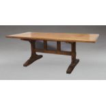 A country oak dining table, 20th century, the solid plank top raised on trestle base, with stamp for