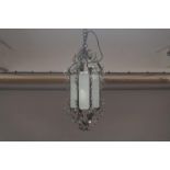 A modern octagonal wrought iron ceiling lantern, with acanthus leaf and scrolling foliate design and