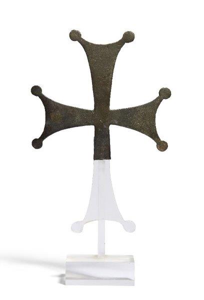 A Byzantine fragmentary bronze cross, 6th-8th century, solid cast, the arms forked at their tips,