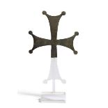 A Byzantine fragmentary bronze cross, 6th-8th century, solid cast, the arms forked at their tips,