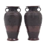 Two Chinese bronze vases, 20th century, each with twin handles to the neck, the bodies with all-over