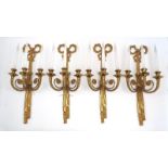 A set of four Regency style gilt bronze three-branch wall lights, 20th century, each with ribbon-