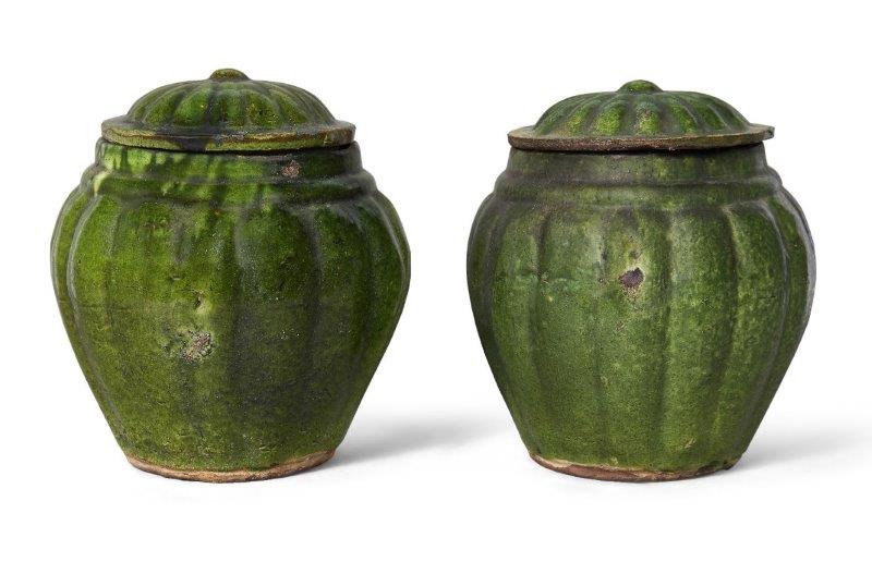 A pair of Chinese pottery green-glazed jars and covers, Ming dynasty, each jar with lobed sides that