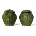 A pair of Chinese pottery green-glazed jars and covers, Ming dynasty, each jar with lobed sides that
