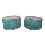 A Pair of lead planters, late 19th century, green painted with sun burst motifs, 30cm high, 58cm