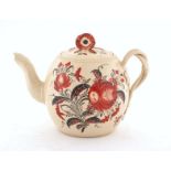 A creamware teapot, 18th century, the body and lid painted with iron red floral decoration, with
