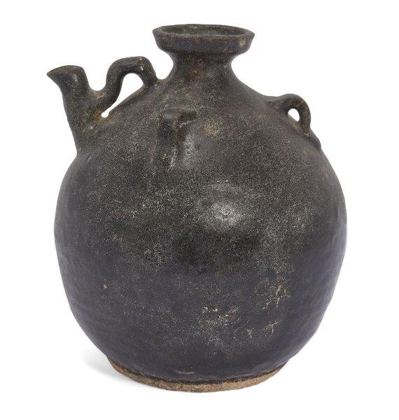 A Chinese pottery black-glazed ewer, Song dynasty, of globular form, the shoulder applied with three