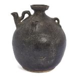 A Chinese pottery black-glazed ewer, Song dynasty, of globular form, the shoulder applied with three