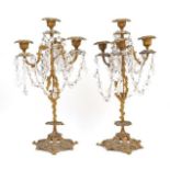 A pair of gilt metal four light candelabra, 19th century, modelled as flowering trees, with cut