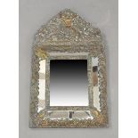 A continental brass clad mirror, 19th century, the crest decorated with a faun amongst foliage,