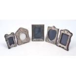 Four small silver mounted photo frames, including one with tulip decoration to border, London, 1987,